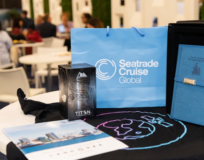 Branded gift items laid out at a Seatrade Cruise event