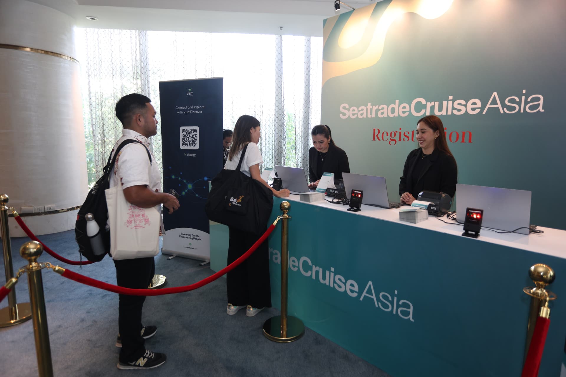 Attendee collecting a lanyard at a sponsored registration desk